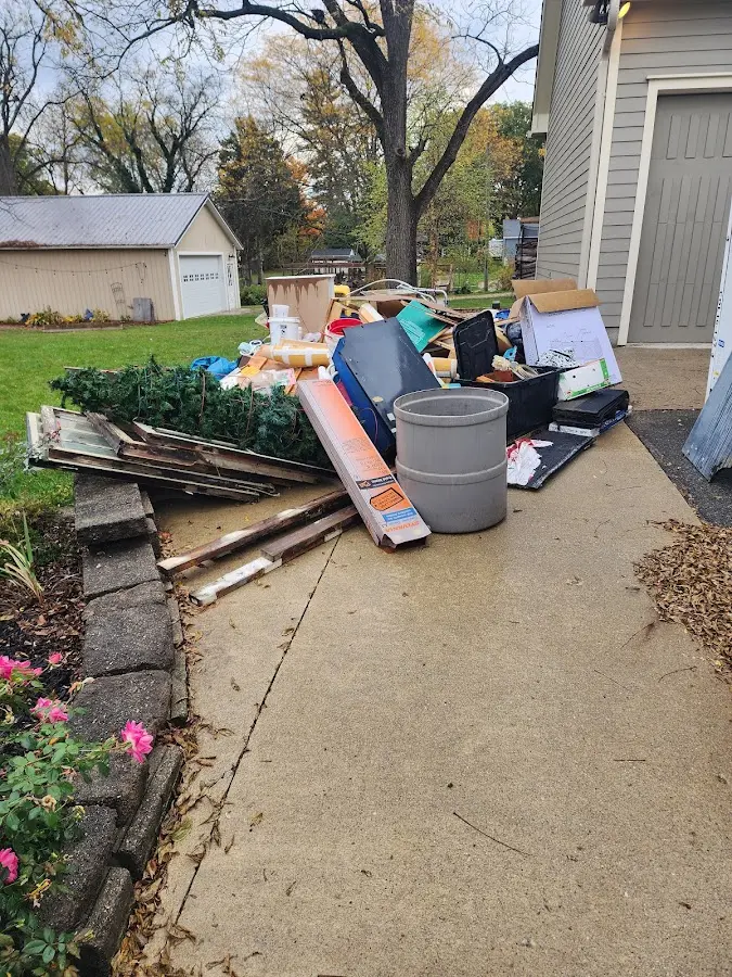 Dumpster being loaded with debris for 12 Yard Dumpster Rental in Newberg